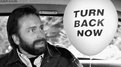 GIF of John Ritter holding a balloon that says on it TURN BACK NOW