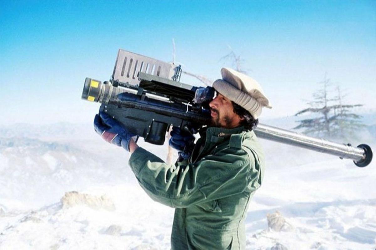 An Afghan mujahideen aims a FIM-92 Stinger missile at passing Soviet aircraft, 1988