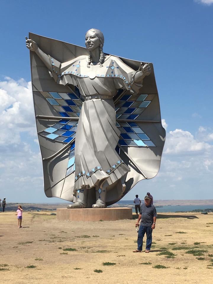 New 50ft statue “Dignity” that just went up in South Dakota. 

The stainless steel statue, by South Dakota artist laureate Dale Lamphere, depicts an Indigenous woman in Plains-style dress receiving a star quilt. The sculpture honors the culture of the Lakota and Dakota peoples who are indigenous to South Dakota.
The statue boldly proclaims that South Dakota’s Native cultures are alive, standing with dignity.
When interviewed after the dedication, Lamphere said “It’s been well received by the Native community, and by visitors from all over the country. My hope over time is it really gets people to think about the beauty of the native cultures.”