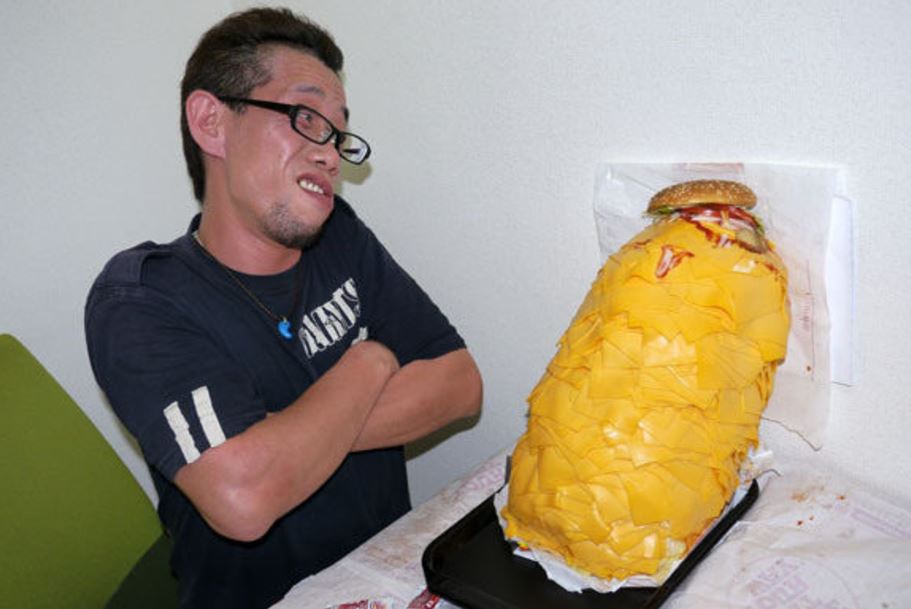 I can't quite tell if that's the face of regret or that of a man who's about to go HAM on a mountain of processed cheese.