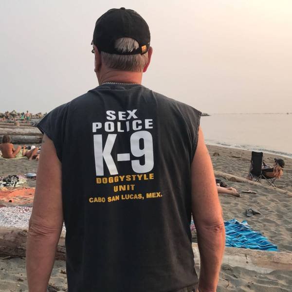 Man wearing shirt that he is with k-9 unit, the small print is a bit more dirty minded