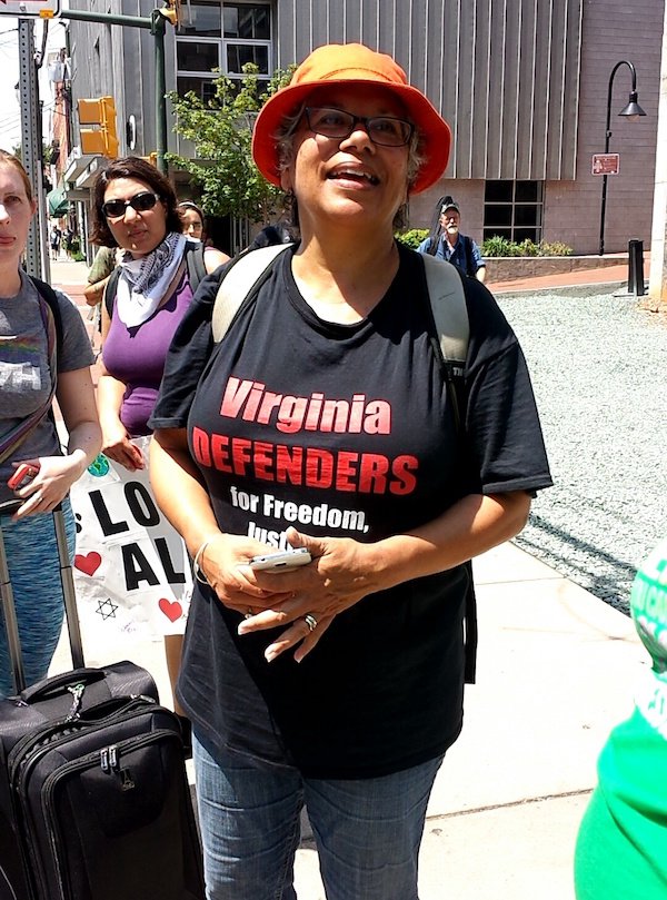 “I was in Charlottesville and nearly missed getting killed or injured by the car that murdered Heather Heyer because I stopped to take a picture. I got to Cville late in the morning. I parked far away and heard the protest had been broken up and there was violence so I decided to walk down Water St. And stay away from the park where the statue is. As I was walking East on Water St. I ran into a very large group of counter protesters who were cheering etc… I decided I was going to turn the corner at 4th St. And go up to the pedestrian mall. Right as I got to the corner a feeling just made me turn around to look behind me. This older black lady was standing quite a ways behind me just looking at me smiling. I don’t know why my eyes picked her out in that big crowd. She had a shirt on that said Virginia defenders for Freedom. There was something about how happy her face was so I turned around and walked back towards her to get a picture. In doing so I walked out of harms way, because literally as soon as I clicked the picture the vehicle driven by that crazy asshat hit everyone and the two cars he slammed into wound up right where I had been standing.”