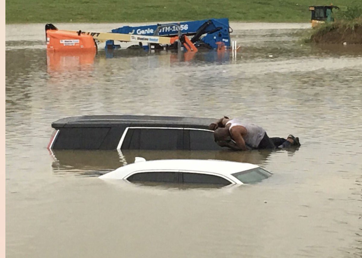 This man is a preacher, Brian Roberson, Jr., checking for people inside cars. On the 610 & 288 in Houston