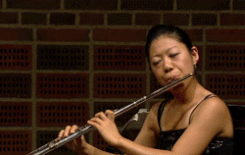 Cool gif of flute player not being distracted by butterfly on her face