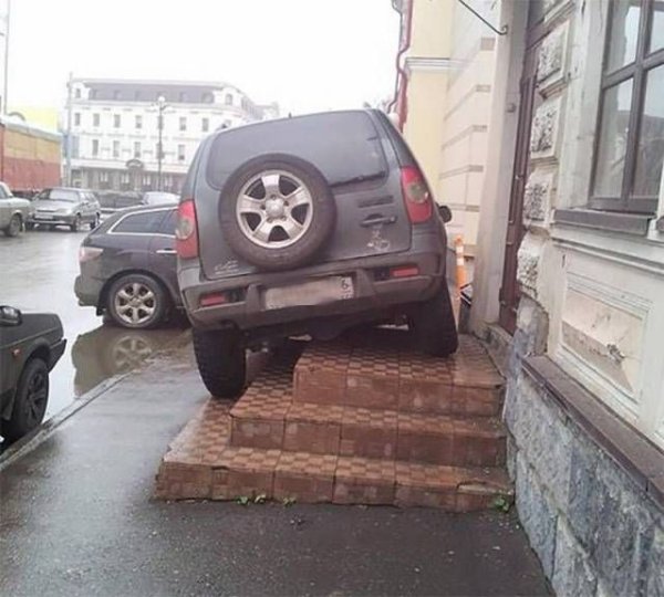 SUV parked diagonally on a few steps.