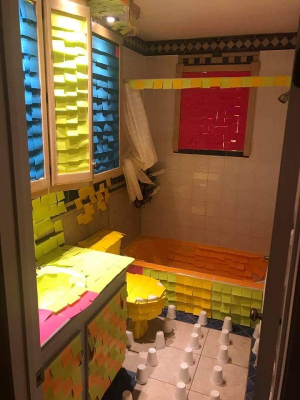Bathroom covered in post it notes