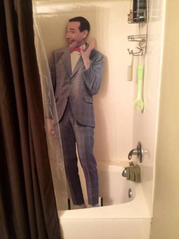Pee Wee Herman cutout hilariously in a shower stall.