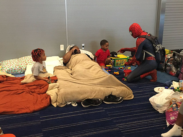 Spider man attends some of the evacuees from Hurricane Harvey.