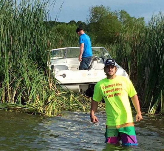 Man wearing shirt that says SEEMED LIKE a good idea at the time with boat stuck