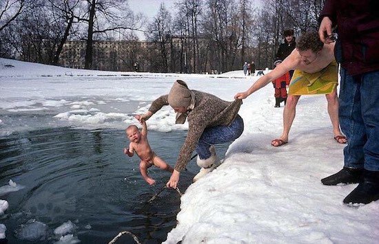 Crazy pic of naked baby getting dunked in the ice cold water