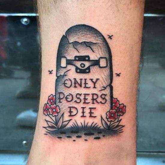 Tattoo of a skateboard gravestone that says Only Posers Die