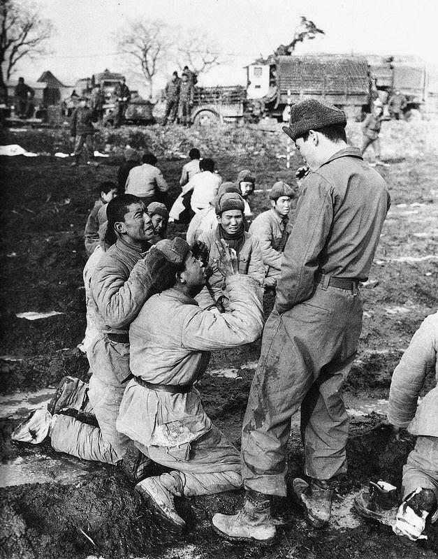 Captured Chinese Soldiers beg for their lives to a South Korean Soldier thinking that they are going to be executed, Korea 1951