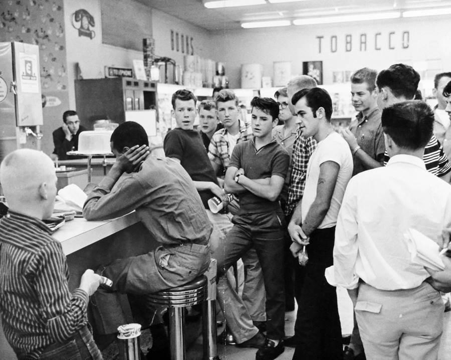 Activist Dion Diamond sitting on a counter stool during a civil rights sit-in, Arlington, 1960