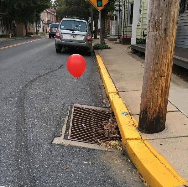 red balloons on sewer