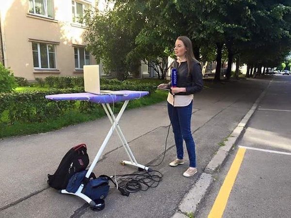Only in Russia pic of woman on the news scene but cameraman is an ironing board.