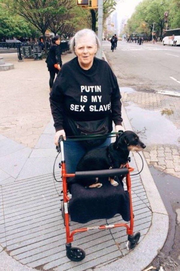 Woman with walker and a dog and shirt that alludes to her being a big fan of Putin.