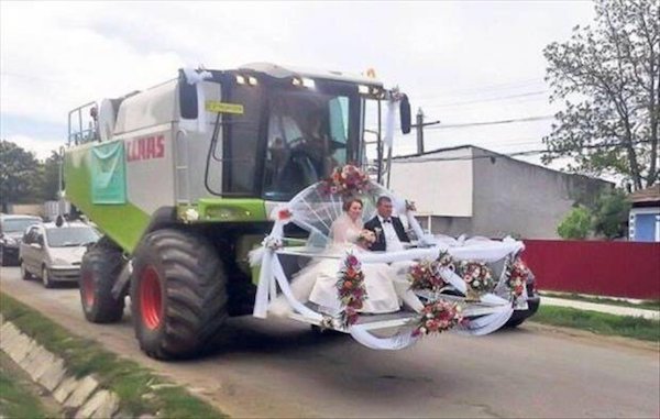 Wedding couple being escorted in a cotton picker