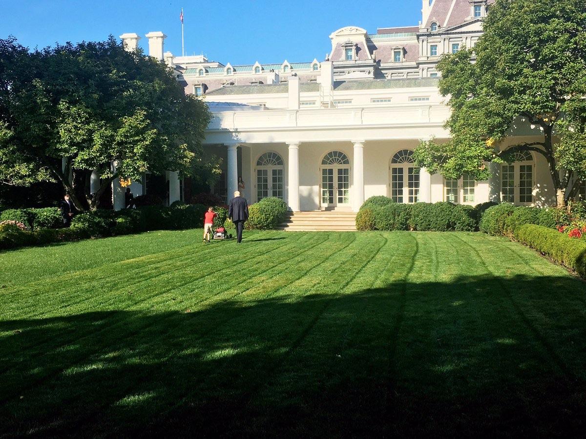 President Trump walking with a boy who asked if he could mow the White House lawn, and was allowed to