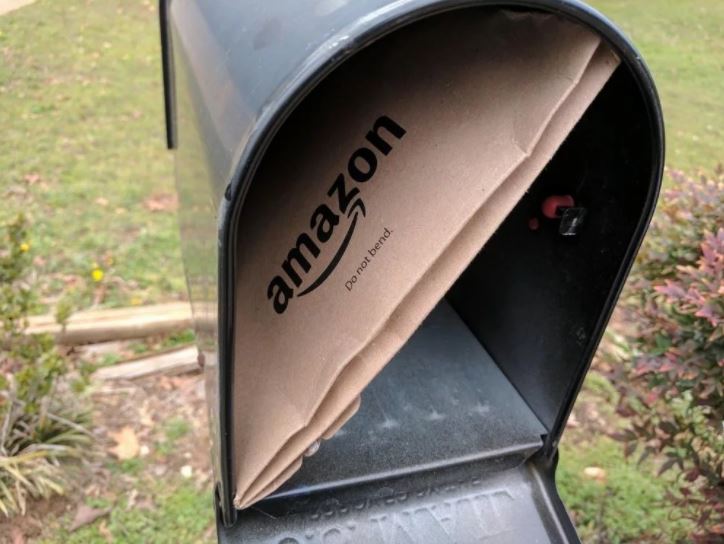 Amazon envelope stuffed into mailbox
