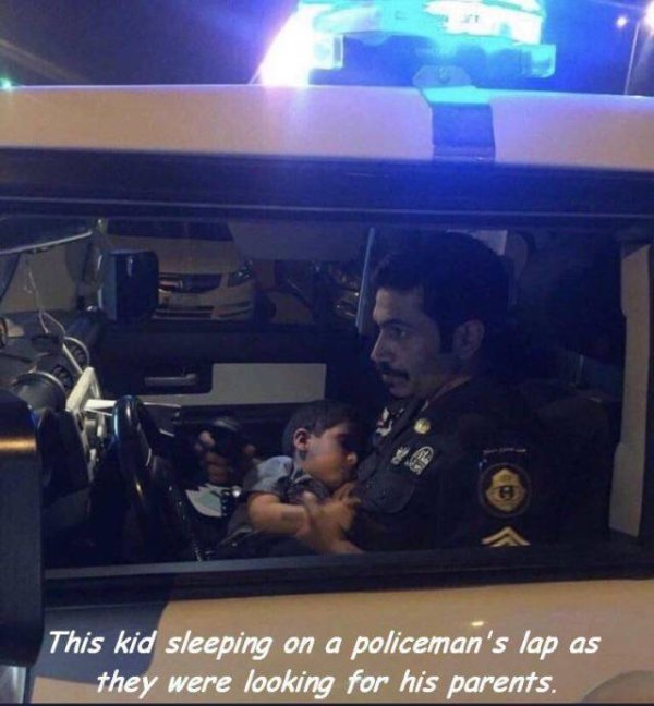 This kid sleeping on a policeman's lap as they were looking for his parents.