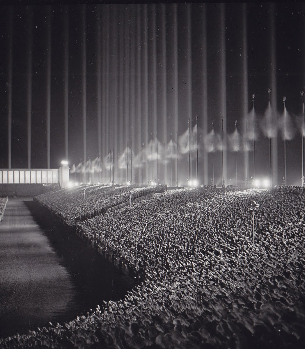 Nazi Rally being held at the “Cathedral of Light” in Nuremberg. Designed by Albert Speer, the “cathedral” actually consisted of 152 anti-aircraft searchlights, at intervals of 12 metres, aimed skyward to create a series of vertical bars surrounding the audience. 1930’s.