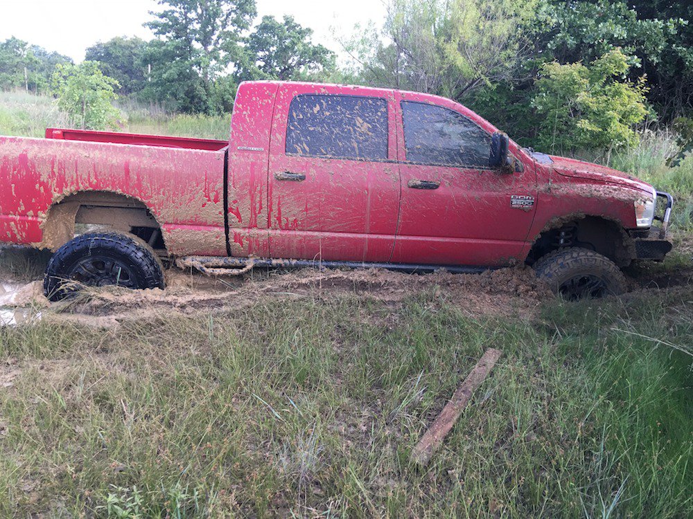 Pickup truck stuck in the mud pretty badly