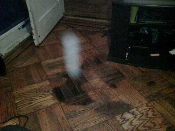 “I pulled up some carpet at the apartment I grew up in Queens, NY because I knew there was perfectly good wood floor under it. After putting the room back together I noticed a dark stain that kind of looked like a body. Almost like a body was left there for a long time and stained the floor so I snapped this pic. Sorry for the quality; it was taken 2008ish on a Blackberry Bold. The white object is what is strange or ‘unexplained’ about the pic, not the stain.”