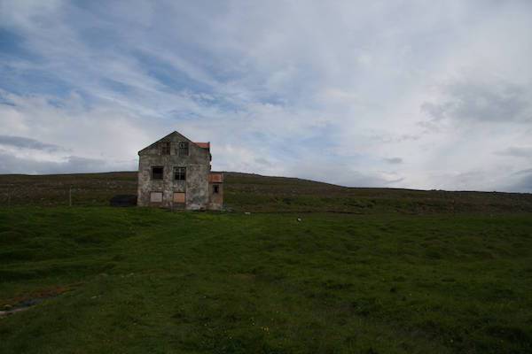 “A lone abandoned farmhouse in north-east Iceland, Langanes. This was real edge-of-the-Earth stuff, a few hundred metres from the Arctic Ocean, about 10km from the nearest sealed road, and not a single soul for miles.
I was on my own and just headed up to it for a quick explore (I was on fieldwork up there for other reasons), went inside. It wasn’t too messed up inside, not much furniture, some things left in the kitchen with a homemade poster saying “AETTARMOT 1982″, a festival that celebrates the bringing in of sheep before the winter, so it was abandoned at some point after then.
I was about to go to the top floor and heard a crrreeeakkkk. Stopped and listened for a few seconds, nothing else. Fine. Went up two more steps, heard the creak again and GENUINELY two or three footsteps, or at least the sound of it. This really got the hairs on my neck up. Now, logically I knew there was essentially zero chance of anyone else being in there, and I enjoy thinking of myself as a reasonable, not-easily-spooked man. I went up one more step, then heard two more footsteps, and something slam onto the floor above.
I legged it.”