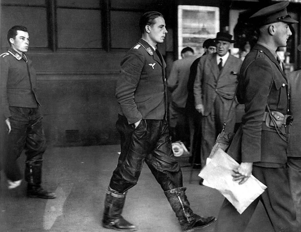 Under British military escort, two captured Luftwaffe crewmen walk out of the London Underground, 1940