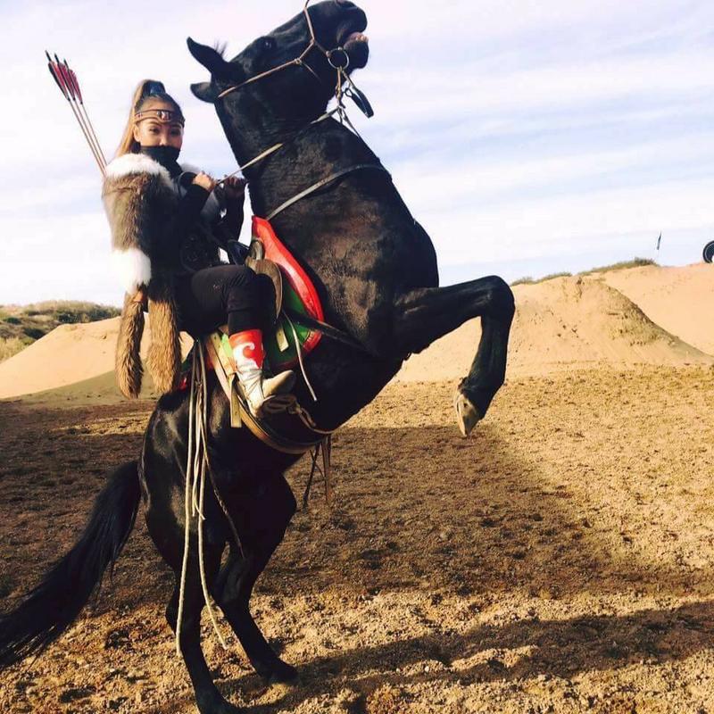 Mongolian Girl Riding A Horse