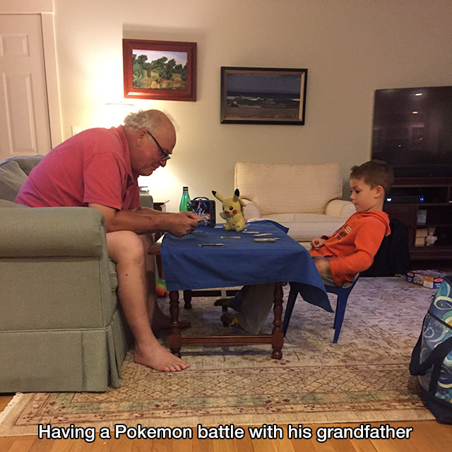 A grandpa plays pokemon with his grandson.