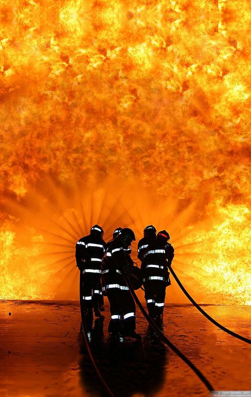 Firefighters Against a Wall of Fire