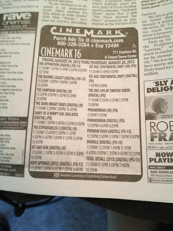 looking up movie times in the newspaper