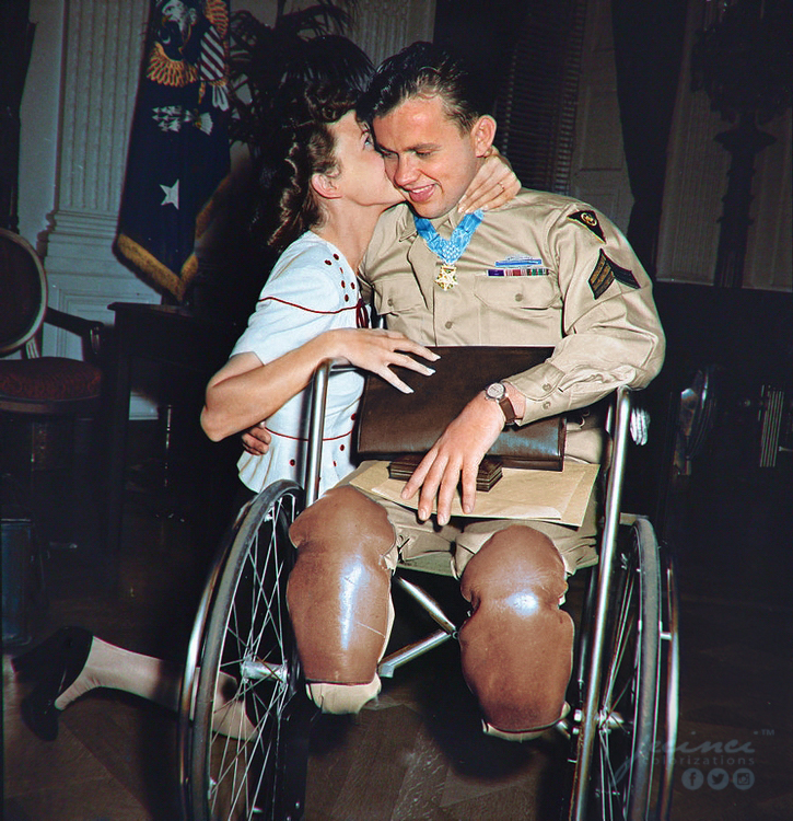 Ralph Neppel wearing his newly awarded Medal of Honor around his neck, gets kissed in the White House by his fiancee, Jean Moore. – September 10, 1945