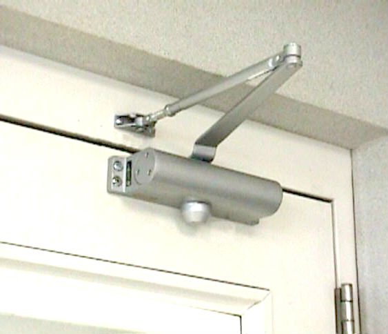 Gradually increase the pressure required to open the office door by adjusting the automatic door-closer with a screwdriver so they become accustomed to giving it a mighty shove then one day disconnect the arm altogether.