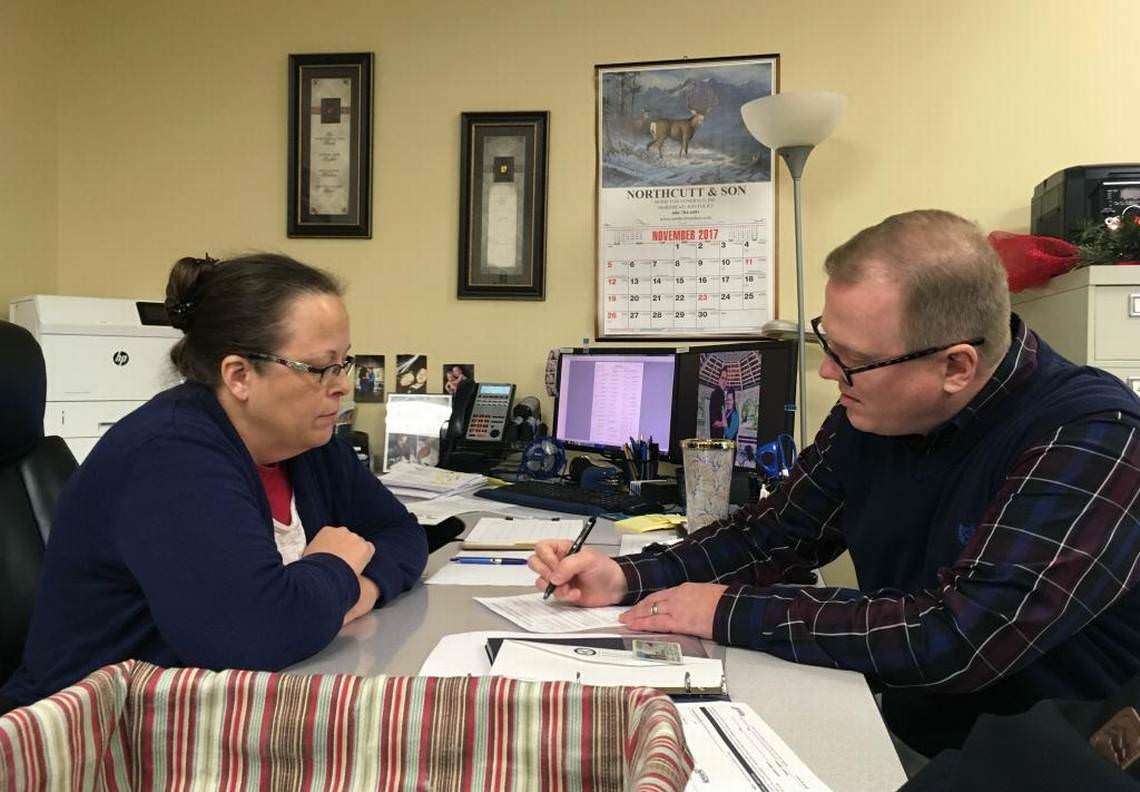 David Ermold, right, files to run for Rowan County Clerk in Kentucky as Clerk Kim Davis looks on. Davis denied Ermold and his husband a marriage license two years ago because she was opposed to gay marriage.