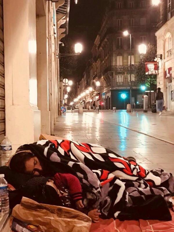 A homeless woman trying to keep her 4 year old son warm. Boardeaux, France