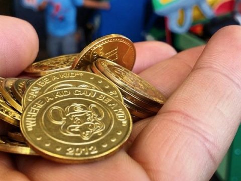 Back in highschool, we had a row of vending machines.

I used ChuckECheese tokens to get snacks for a MONTH. I guess they fixed that permanently because of me. Whoops! :)

I guess the rule that applies to is "Legal tender only" ?