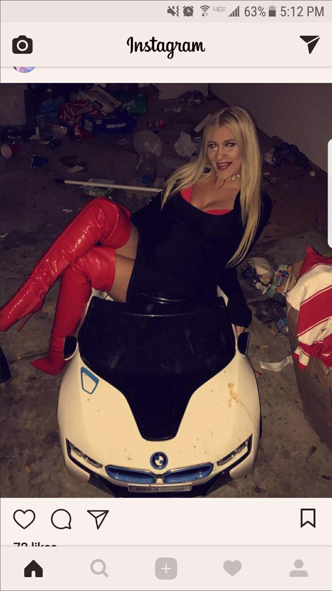 woman posing in a child's toy car