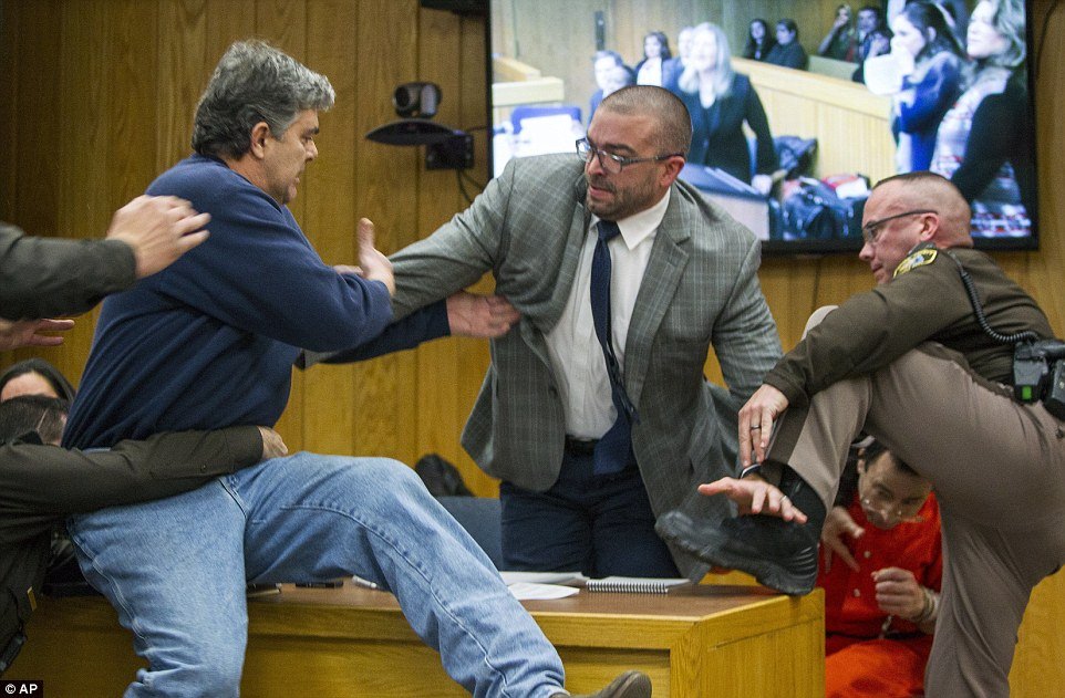 Father of three daughters who were abused by Larry Nassar lunging at him in court