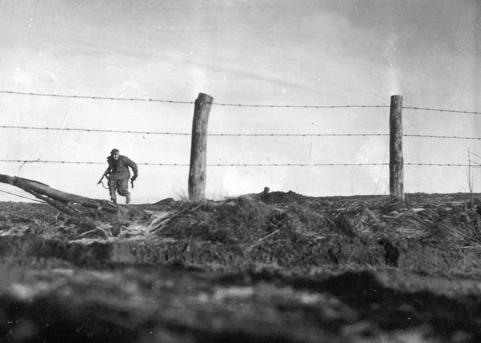 An infantryman from the U.S. Army’s 82nd Airborne Division goes out on a one-man sortie while covered by a comrade in the background, near Bra, Belgium, on December 24, 1944.
