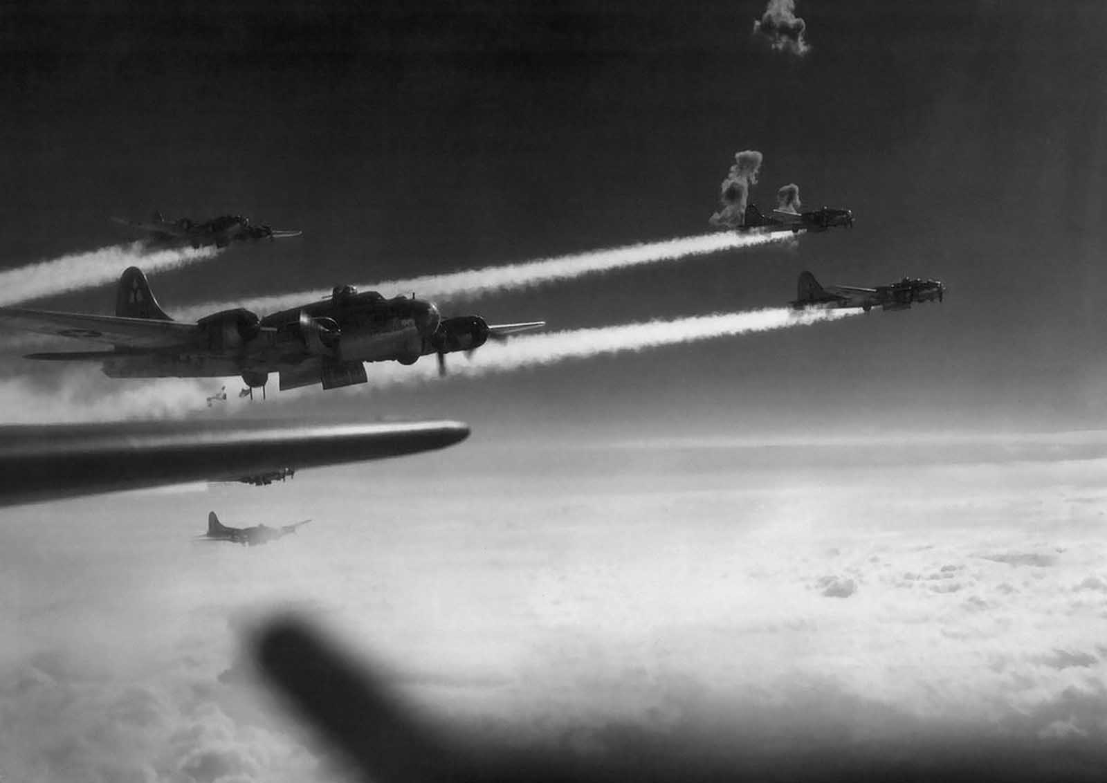 Flak bursts through the vapor trails from B-17 flying fortresses of the 15th air force during the attack on the rail yards at Graz, Austria, on March 3, 1945.