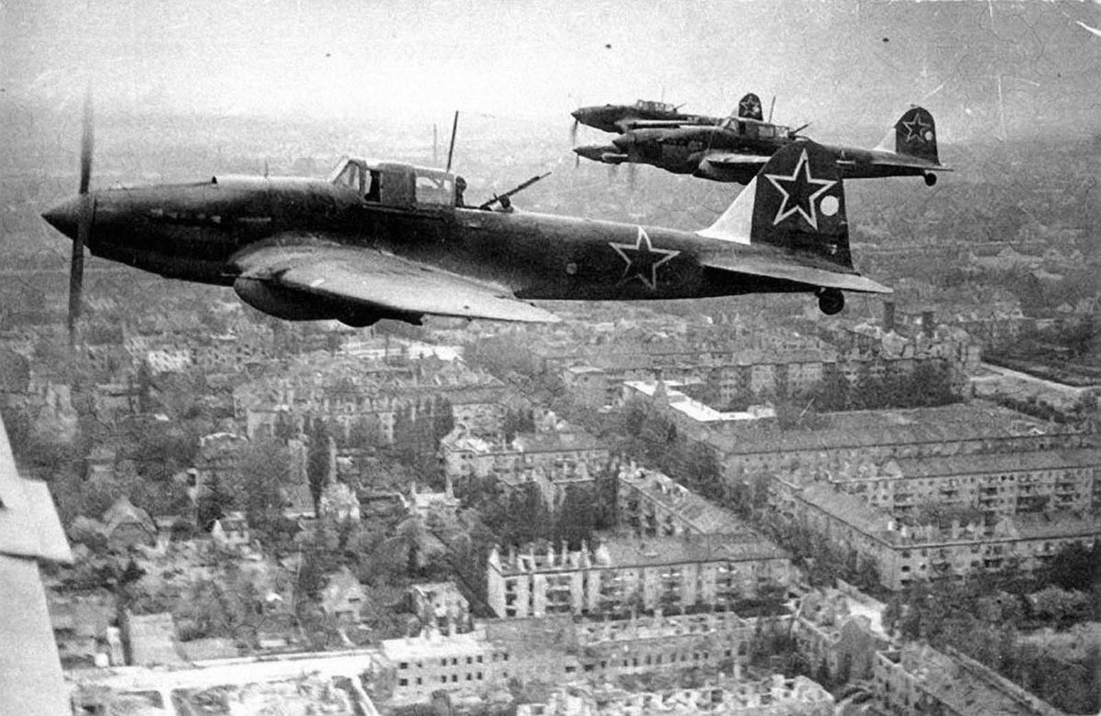 Soviet Ilyushin Il-2 ground attack aircraft fly in the skies above Berlin, Germany in 1945.