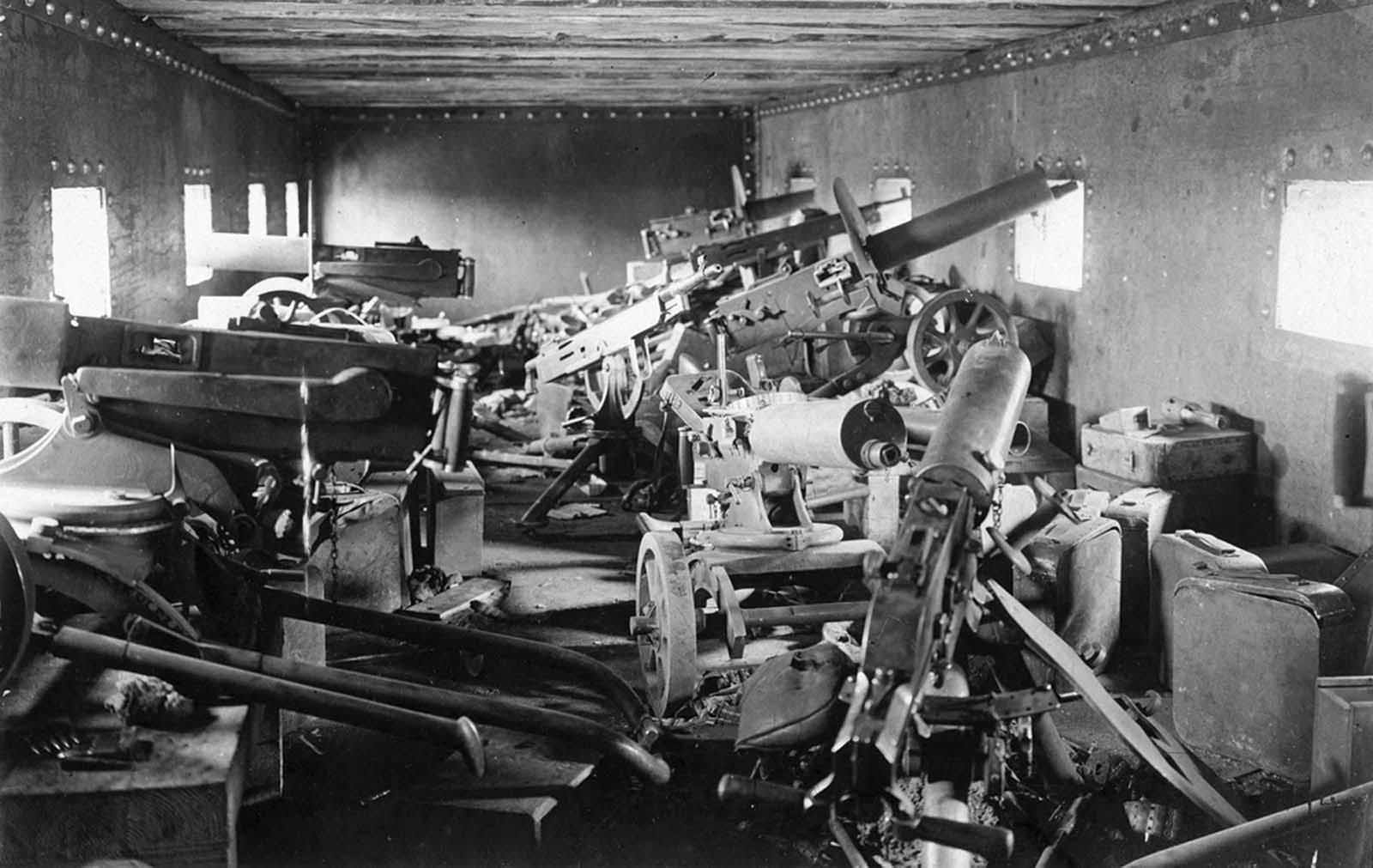 The interior of an armored train car, Chaplino, Dnipropetrovs’ka oblast, Ukraine, in the spring of 1918. At least nine heavy machine guns are visible, as well as many ammunition cases.
