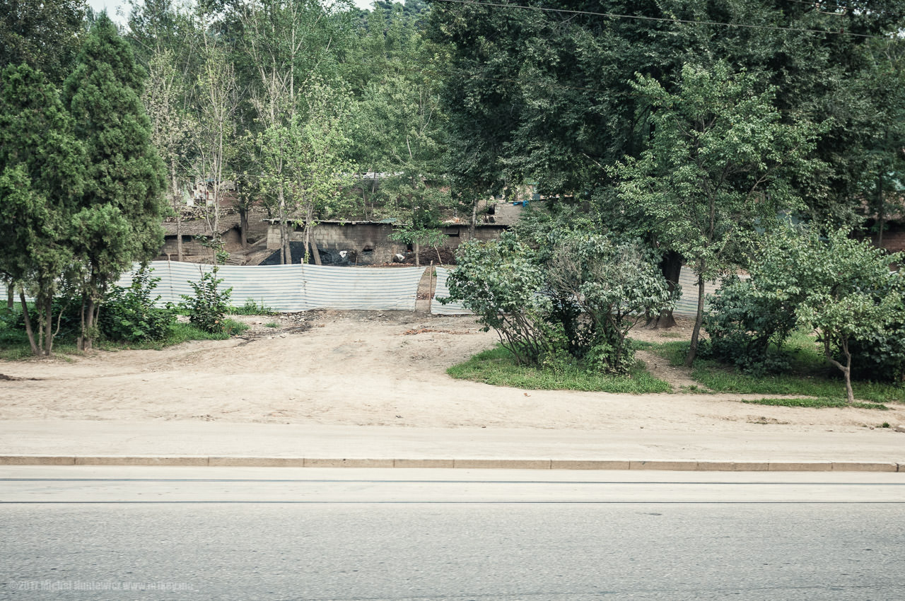 As we were leaving Pyongyang in our minibus, I spotted these slum-like structures by the road. Since this was not a place they wanted us to photograph, they were driving real fast, but I managed to snap this.