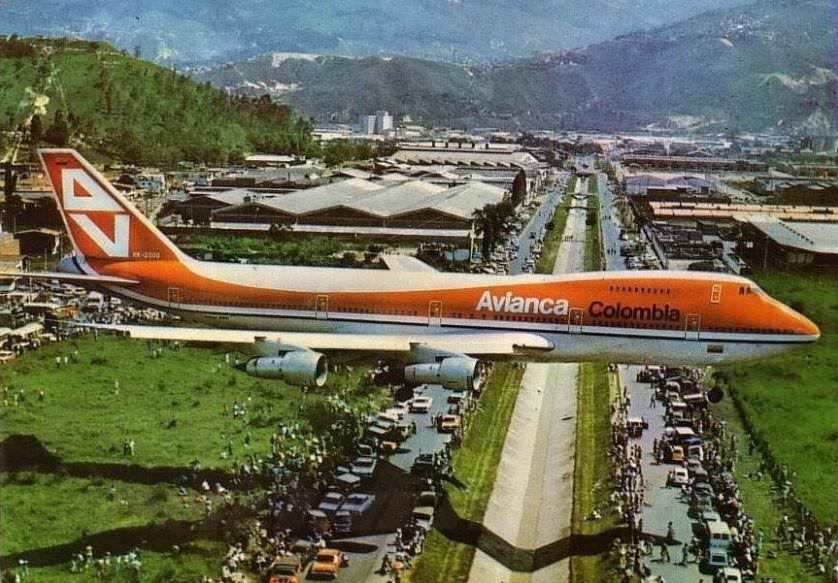 People gather to watch the first ever Boeing 747 to land in the small airport of the city of Medellin Colombia (1976).
