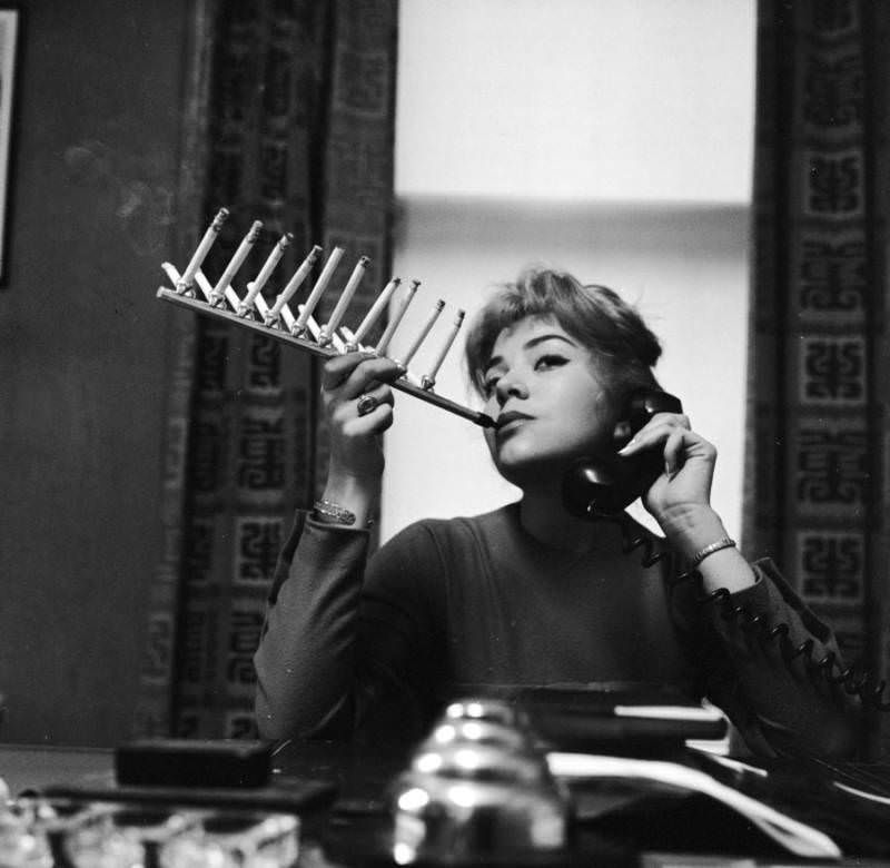Cigarette pack holder with model Frances Richards in the US, in 1955.