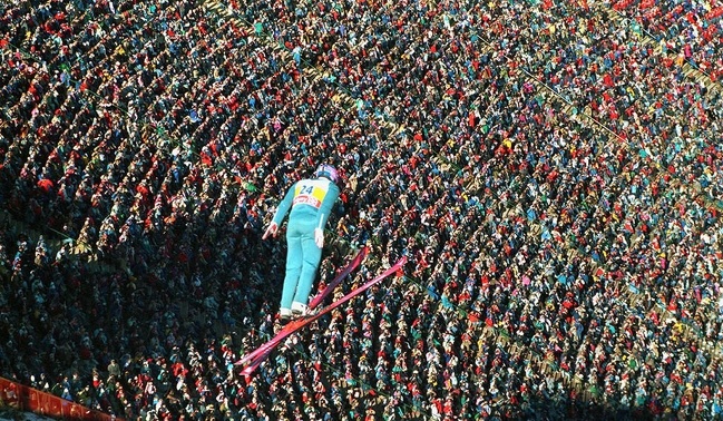 Eddie “The Eagle” Edwards soars above a roaring crowd at the 1992 Calgary Winter Olympics.