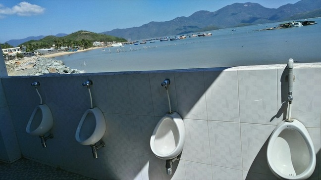 Urinals overlooking the beach or on the opposite side the beach overlooking urinals.