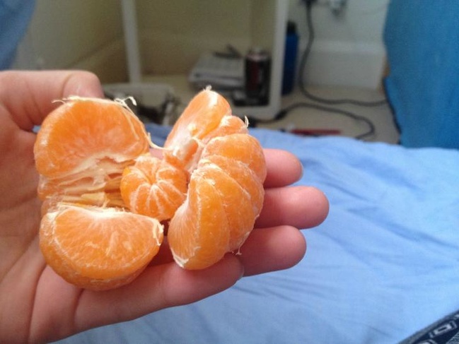 A mini tangerine inside of a tangerine. Looks like a Russian doll.